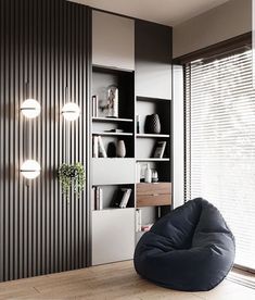 a bean bag chair sitting in front of a bookshelf