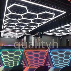 the interior of an office building with colorful lights on the ceiling and chairs in front of it