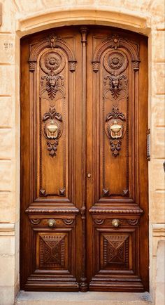 two wooden doors with ornate carvings on them