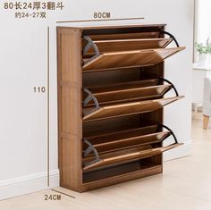 an image of a wooden shoe rack on the floor with measurements in front of it