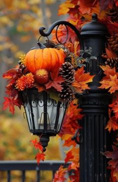 a lamp post decorated with fall leaves and pumpkins