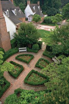 an aerial view of a garden in the middle of a yard with trees and bushes