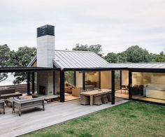 a modern house with glass walls and wood decking