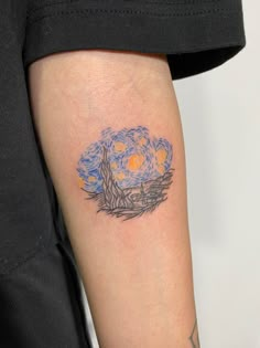 a person with a tattoo on their arm that has a starry night in the sky