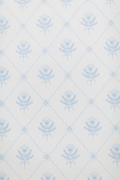 a blue and white wallpaper with flowers on it