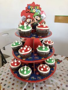 cupcakes are stacked on top of each other in the shape of a christmas tree