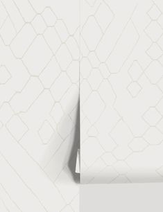 an abstract white wallpaper with lines and shapes in the middle, on top of a plain surface