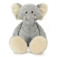 an elephant stuffed animal sitting up against a white background