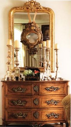 an antique dresser and mirror in a room