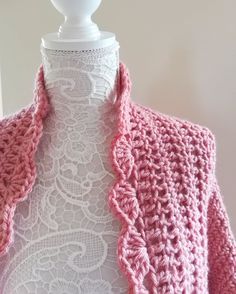 a white mannequin with a pink crochet jacket on top of it