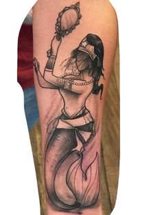 a black and white tattoo of a mermaid holding a bottle