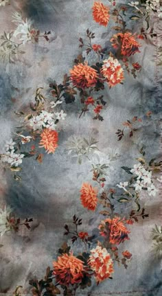 a blue and orange floral print fabric with white flowers on the bottom half of it