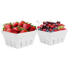 two white bowls filled with berries and cherries on top of each other in front of a white background