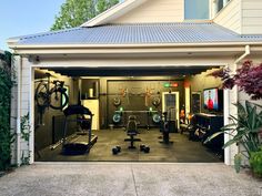 an open garage door with various exercise equipment in the front and side doors on both sides