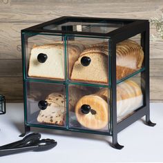 three glass boxes with bread in them