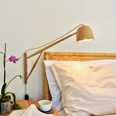 a table with a book, cup and lamp on it