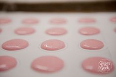 several pink dots are arranged on a white surface