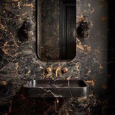 a bathroom sink sitting under a mirror next to a wall mounted faucet in a room