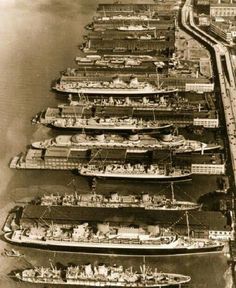 an aerial view of several ships docked in the water