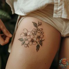 a woman's thigh with flowers on it