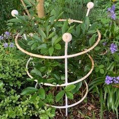 there is a metal plant stand in the garden