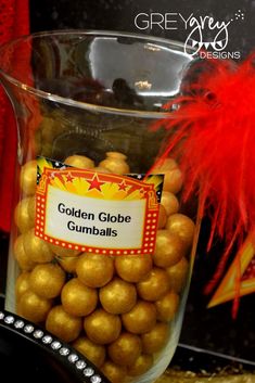 a glass vase filled with golden globe gumballs