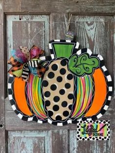 a door hanger with a polka dot pumpkin on it