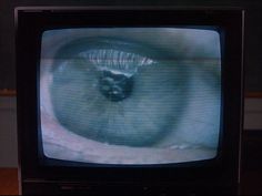 an old television with the image of a cat's eye on it