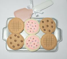 cookies decorated with icing and sprinkles on a cookie sheet