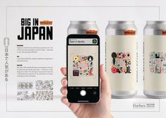 a person holding an iphone in front of a can of japanese beer with stickers on it