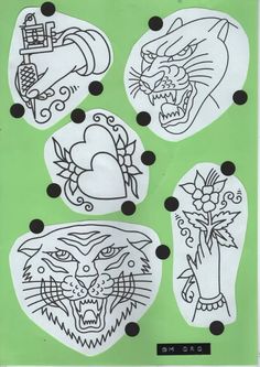 some drawings on a green paper with black dots and white circles in the shape of cats