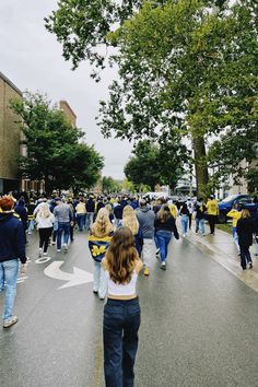 a group of people walking down a street