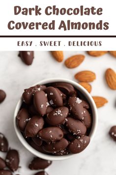 dark chocolate covered almonds in a white bowl