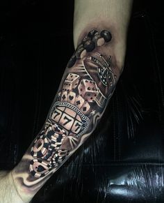 a man's arm with a tattoo on it that has an image of a clock