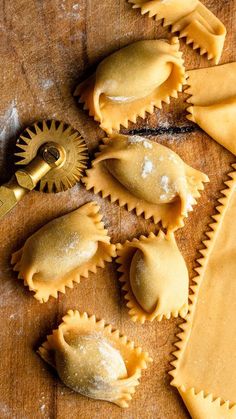 some ravioli on a wooden table with a gold sprinkler