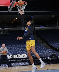 a man dunking a basketball in the air