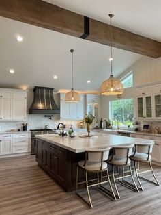 a large kitchen with an island in the middle and lots of counter space on one side