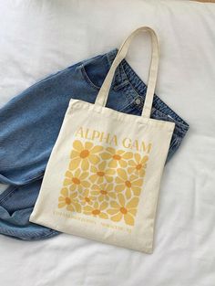 DM US FOR BULK ORDER INQUIRIES. Please include any customizations, the quantity and the deadline in your message! Introducing our stunning floral yellow Alpha Gamma Delta Tote Bag! Perfect for beach days, a day running errands, or simply soaking up the sun in style, this tote is a must-have accessory for every AGD sister. 🌼 Premium Quality: Crafted from durable, high-quality materials, this tote bag is designed to withstand your busy, on-the-go lifestyle. The sturdy straps ensure comfort and co Sorority Merch Handbags, Sorority Tote Bags Painted, Spring Cotton Bags With Letter Print, Sorority Tote Bags, Alpha Gam, Sorority Merch, Floral Tote Bag, Alpha Gamma Delta, Sorority Gifts