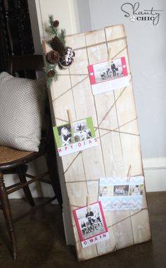 a wooden board with pictures on it sitting in front of a chair and christmas tree