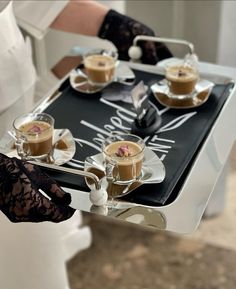 a woman holding a tray with desserts on it