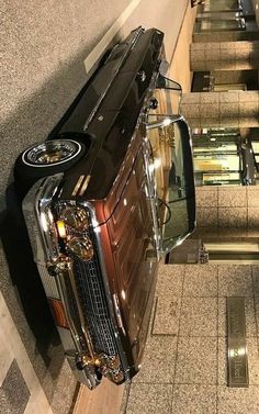 an old car is parked on the escalator