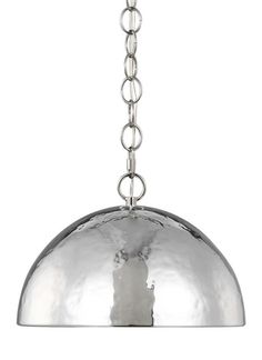 a large metal light hanging from a chain