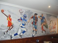 a mural in the corner of a restaurant with basketball players painted on it's walls