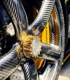 a close up view of the spokes and wheels of a motorcycle with gold accents