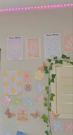 the wall is decorated with many different types of paper flowers and butterfly stickers on it