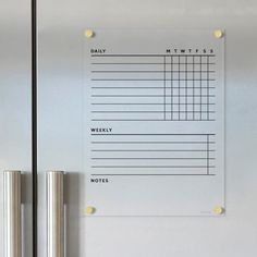 a stainless steel refrigerator with a daily planner on it