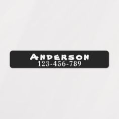 a black and white name plate with the words anderson on it's bottom corner