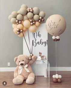 a teddy bear sitting next to some balloons