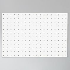 a white wall mounted on the side of a gray wall with polka dot pattern in it