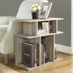 a book shelf with books and a potted plant on top